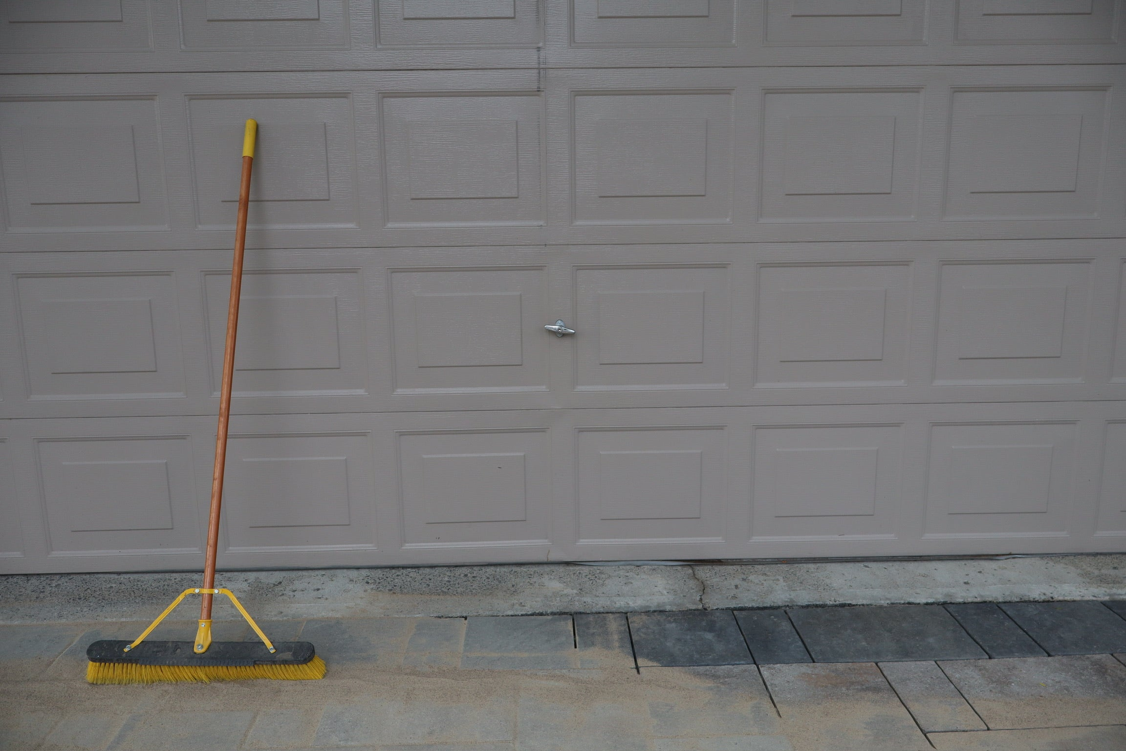 Broom against driveway