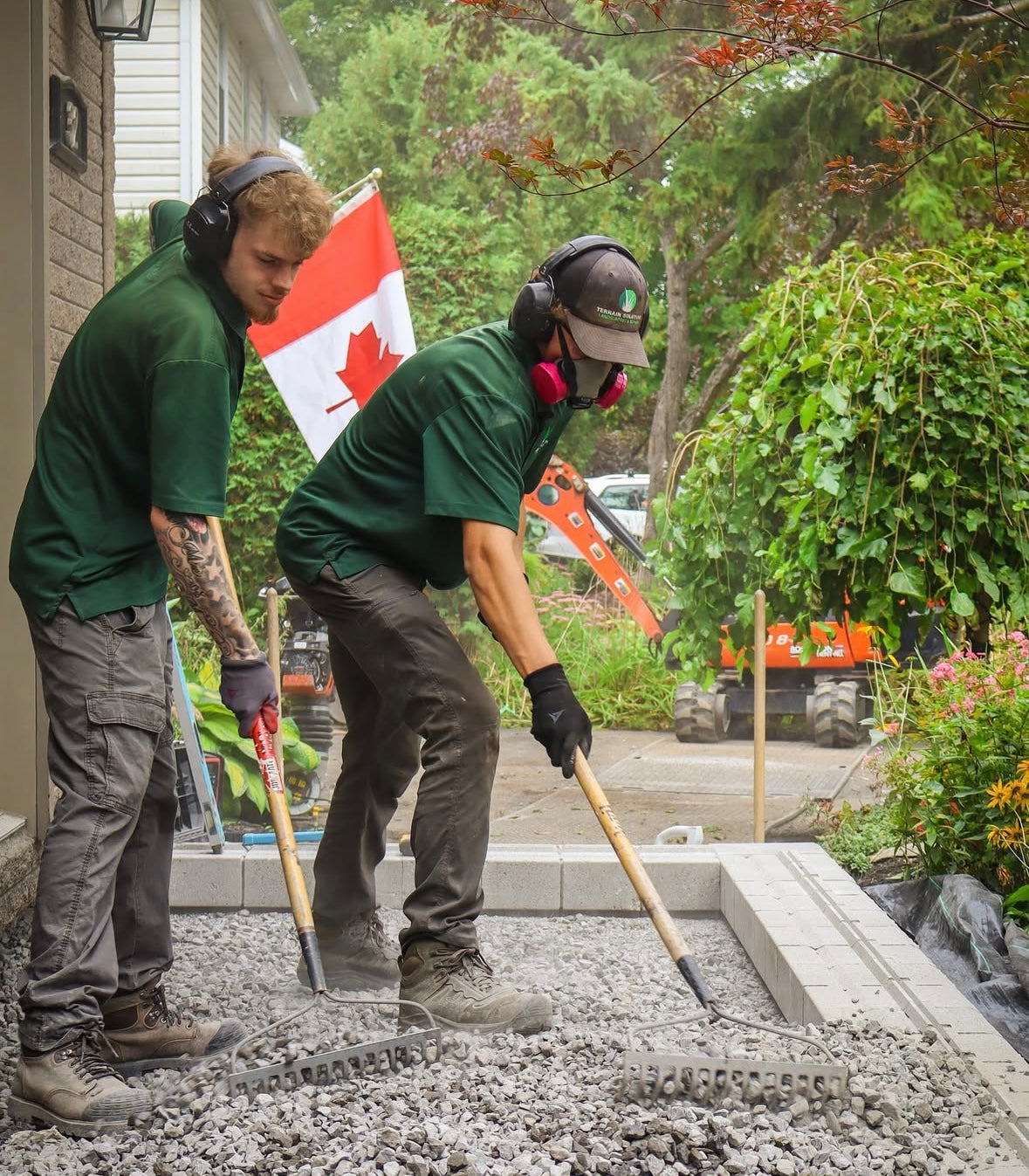 Two employees doing landcaping in canada